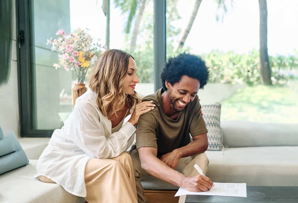 A couple signing remortgaging paperwork